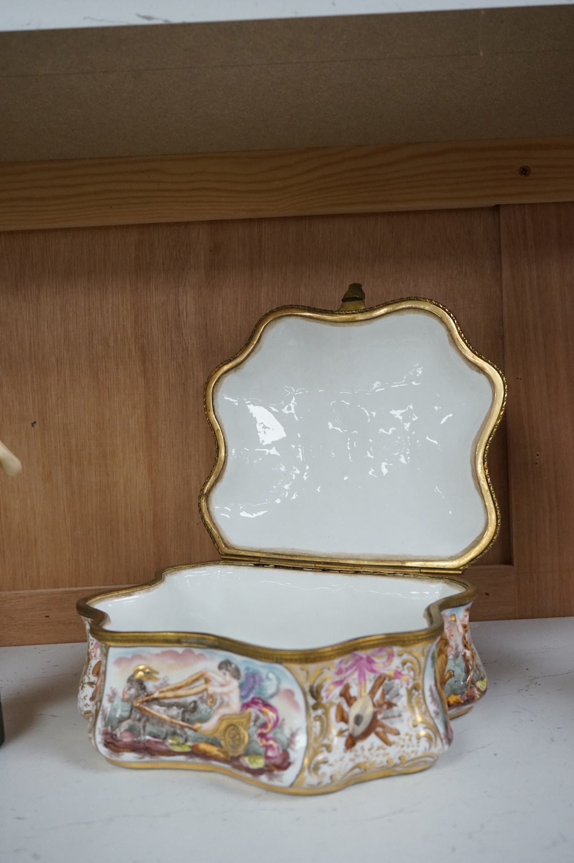 An ornate Neapolitan Capodimonte porcelain box with gilt mounts, 22cm wide, 11cm high